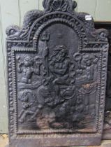 A heavy cast iron fire back of stepped rectangular and arched form with raised relief detail of
