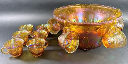 An amber carnival glass punch bowl with eleven glasses, four colourful St Louis champagne flutes,