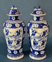 A pair of Chinese export blue and white porcelain lidded vases (with associated hardwood stands),