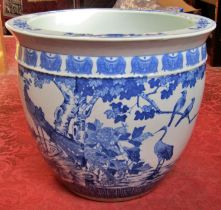 A large Chinese blue and white porcelain jardiniere / fish bowl decorated with birds amongst