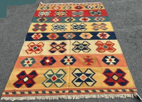 A southwest Persian Qashquai Kilim, with geometric design in tones of ochre, terracotta, and dark