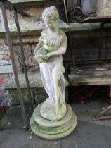 A weathered cast composition stone garden ornament in the form of a standing classical water