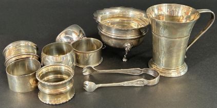A silver group consisting of a sugar basin, milk jug, six napkin rings, etc