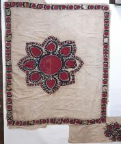 Suzani panel, possibly 19th century with a central hand embroidered flower motif in crimson