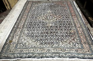 A Persian Kashan carpet, with a central medallion and intricate scrolling floral design in cream and