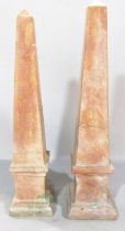 A pair of pale pink obelisks in a marbled finish 34cm high.