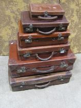 A mixed collection of six leather and other suitcases / luggage to include stitched examples with