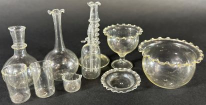 A set of miniature hand blown glass doll’s house glass ware, including carafes, a bowl, beakers,