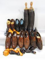 A pair of vintage black leather ladies riding boots supported by wooden boot shoes, a selection of