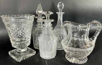 Three late 19th and early 20th century cut glass decanters, a vase and a glass water jug.