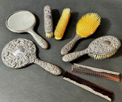 A silver brush and comb set with Green Man mask detail including a pair of mirrors, pair of hair