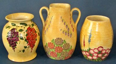 A group of seven Radford pottery jugs and vases, decorated throughout with floral motifs