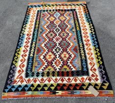 A Chobi Kilim, with a central panel of spiked multicoloured guls, 195cm x 127cm