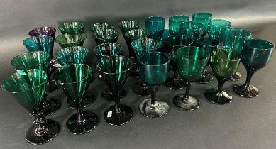 Fifteen trumpet 19th century wine glasses in various shades of green and thirteen similar wine