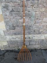 A large traditionally-made agricultural eight-pronged fork, 162cm.