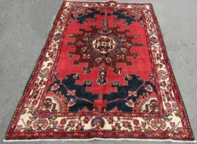 A north west Persian Tafresh rug, with a central medallion design repeating outwards to a running