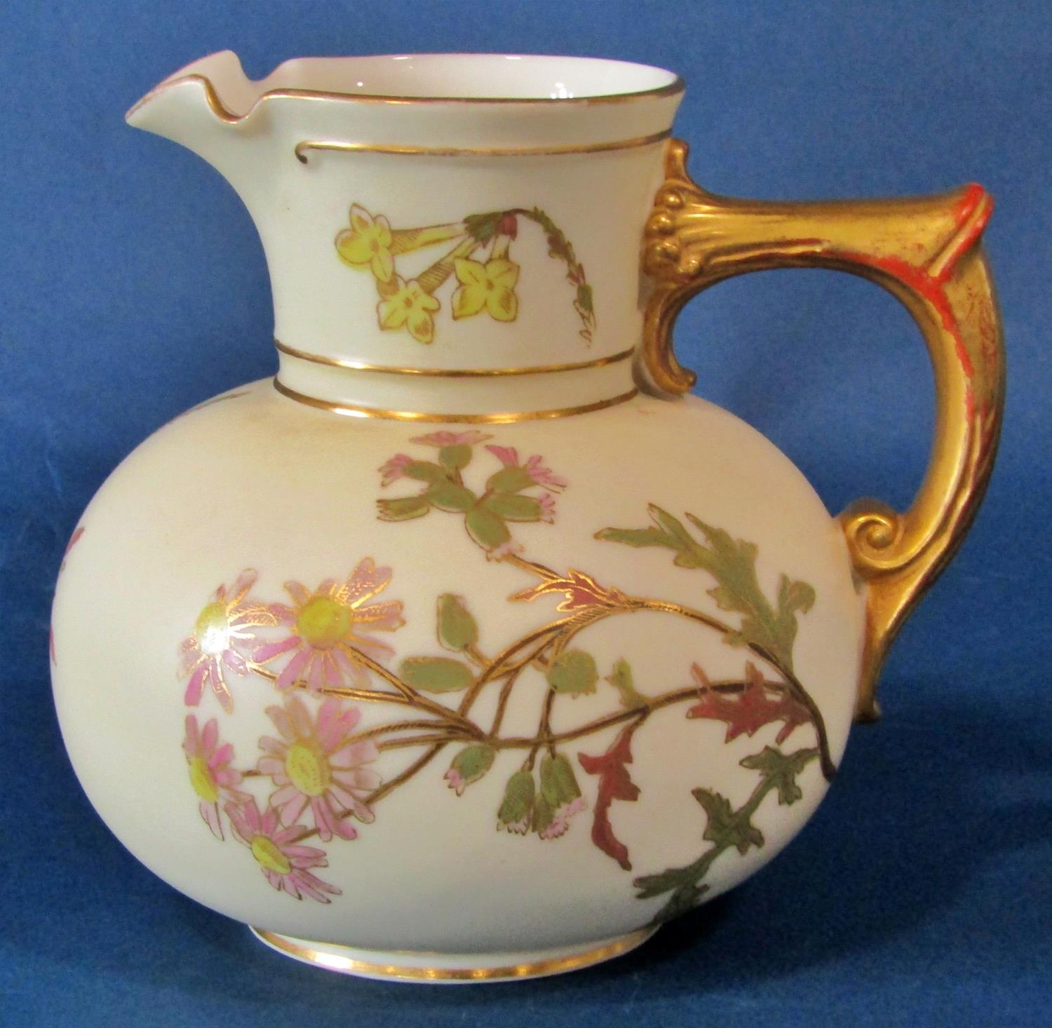 A Royal Worcester blush ivory jug of squat bulbous form decorated with painted floral sprigs, puce