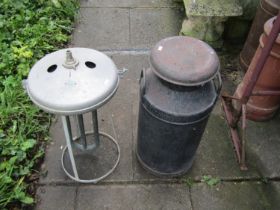 A vintage painted United Dairies milk churn complete with cap, together with a further vintage