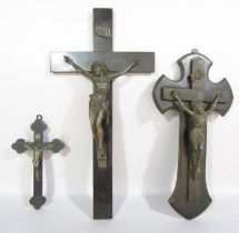 Two wooden crucifixes both with spelter Christs, and a crucifix with a bronze Christ. (3)