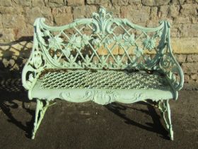 A good weathered light green painted cast alloy two seat garden bench with scrolling Rococo style