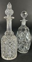 A pair of slender waisted cut glass vases, 29cm high, and two cut glass decanters.