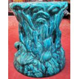 A 19th century majolica type jardiniere stand of tree stump form, decorated with applied shells,