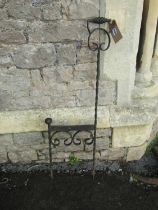 A decorative iron work boot scraper with simple open scroll and twisted bar detail, 35 cm wide x 112