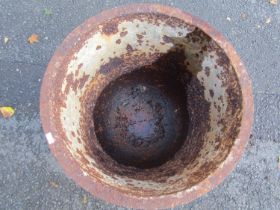 An old weathered cast iron cauldron set/raised on a later associated stand 54 cm diameter x 50 cm (