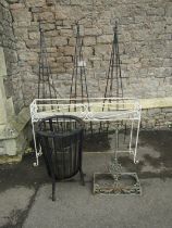 Three tall ornamental garden ironwork obelisks (49cm high) together with a scrolling painted plant