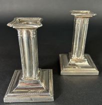 A pair of small square column candlesticks on a spread base, Sheffield 1904, maker Thomas Bradbury &