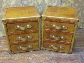 A pair of studded tan leather three drawer bedside chests