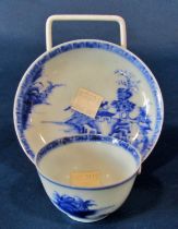 A Chinese Nankin cargo porcelain tea bowl and saucer, with original labels, the bowl measuring 4cm