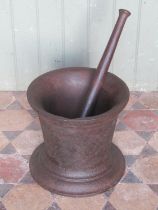 A large 18th century cast iron pestle and mortar (30cm high, 33cm diameter) (possibly maritime)