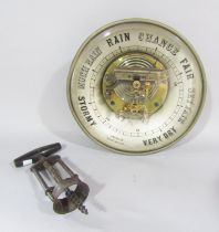 Circular aneroid barometer and a vintage corkscrew.