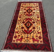 A north east Persian Meshed Belouch rug, with two central medallions on a natural wool field of