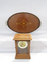 An Edwardian mahogany oval inlaid tray and a mahogany cased mantle clock, (as found)