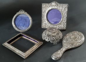 Four silver photo frames, (af) silver ink bottle cover and a silver hand mirror