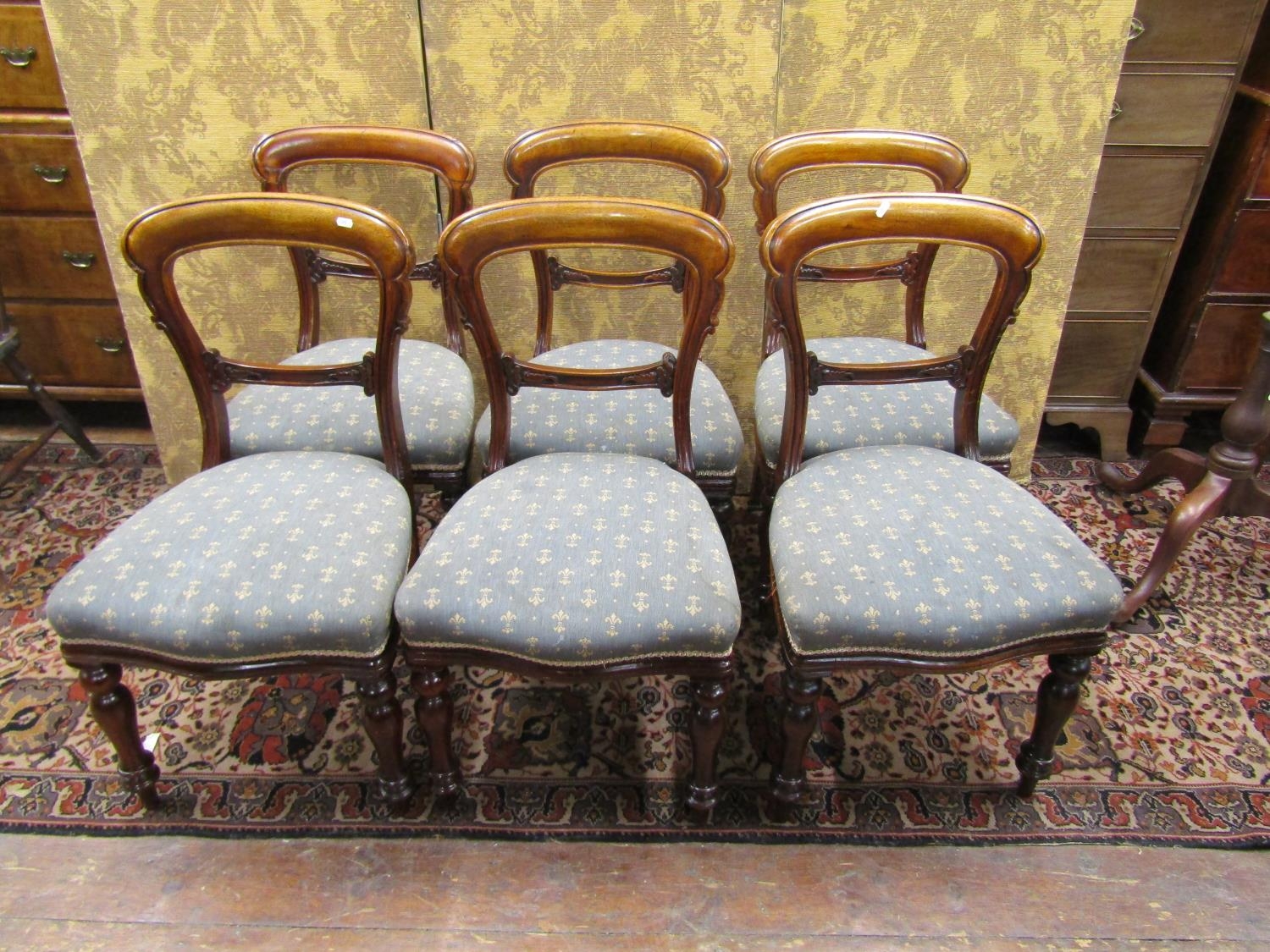 A set of six Victorian mahogany dining room chairs with upholstered seats on turned supports