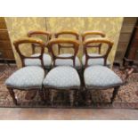A set of six Victorian mahogany dining room chairs with upholstered seats on turned supports