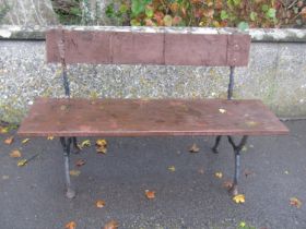 Small two seat cast iron garden bench with stained boarded seat and back, 120cm wide (af )