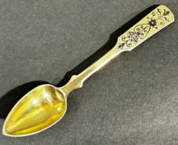 A silver gilt Russian 84 tea spoon dated 1838 indistinct maker with floral and yellow decoration,