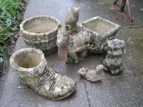 Three small weathered novelty garden planters to include a donkey pulling a cart, and old boot, a