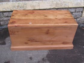 A stripped pine blanket box with loose removable lid and moulded plinth, 92cm long x 46cm wide x
