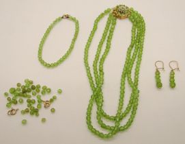 9ct faceted peridot bead suite comprising a three strand choker necklace, the clasp set with a