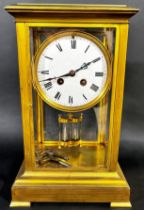 A 19th century four pane brass framed mantle clock with eight day striking movement with mercury