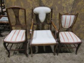 Three Edwardian lightweight chairs, two with inlaid detail, the other with open arms and swept sabre
