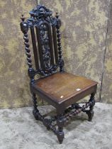 A Victorian carved oak chair, with solid seat, carved fruit and vine, green man and further carved