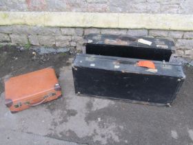 Three vintage travelling suitcases to include a large example, with remnants of original railway