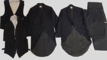 Collection of vintage Eton College boys uniform comprising 2 black tail coats, 3 waistcoats and 4