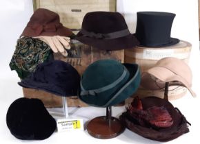 A collection of vintage ladies clothing including felt hats, a simple woven cane/ black silk sun